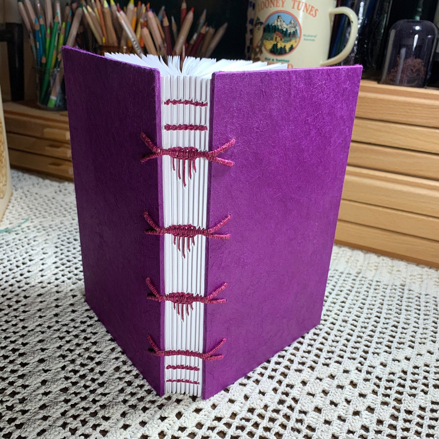 Raised Cord Sewing with Icicle Spine Stiches Covered in Purple Handmade Paper